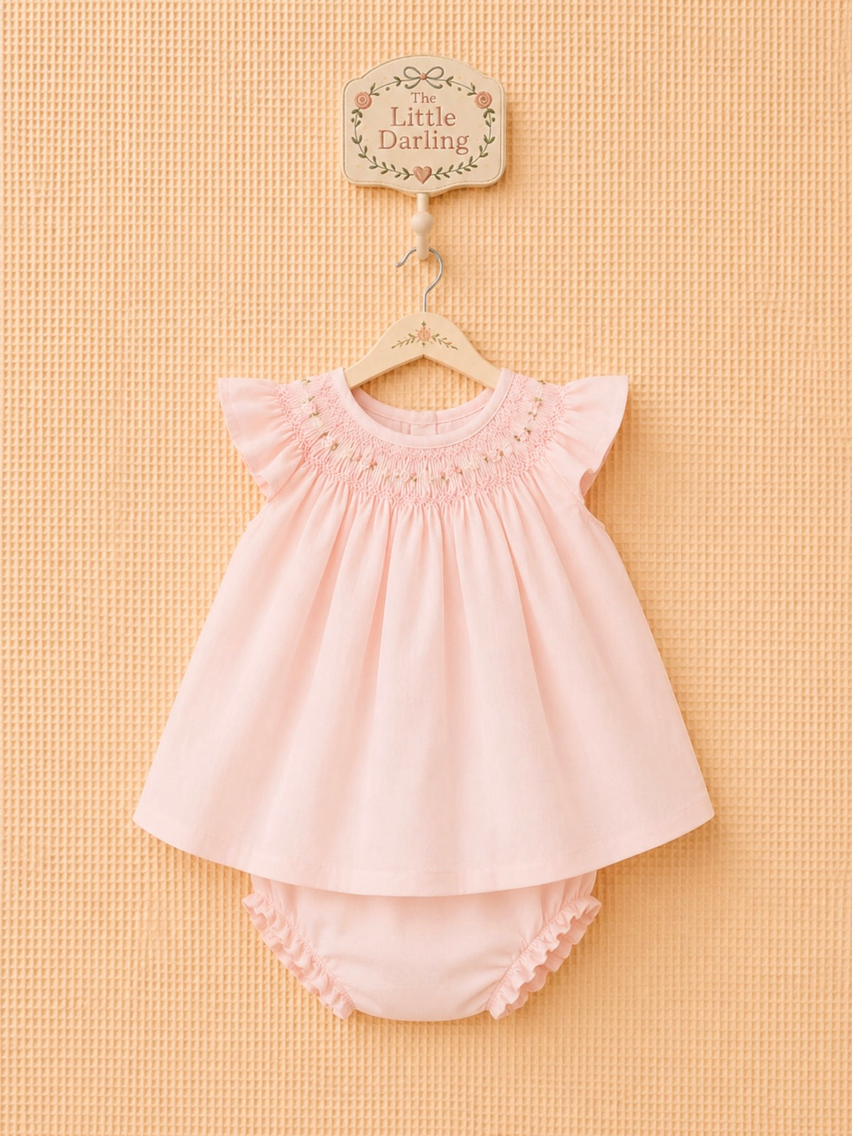 Pink dress with matching ruffled bloomers.