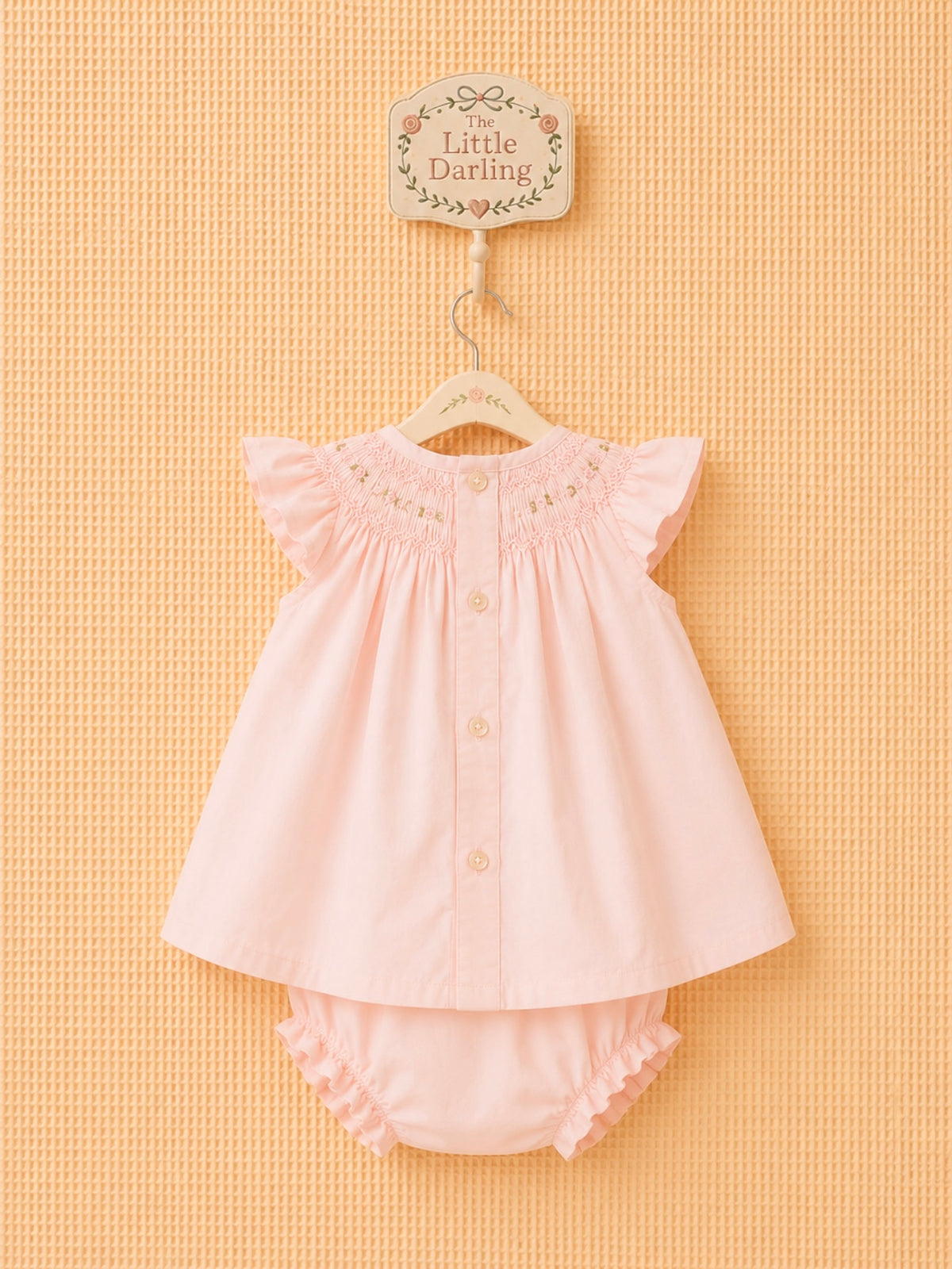 Pink dress with matching ruffled bloomers.